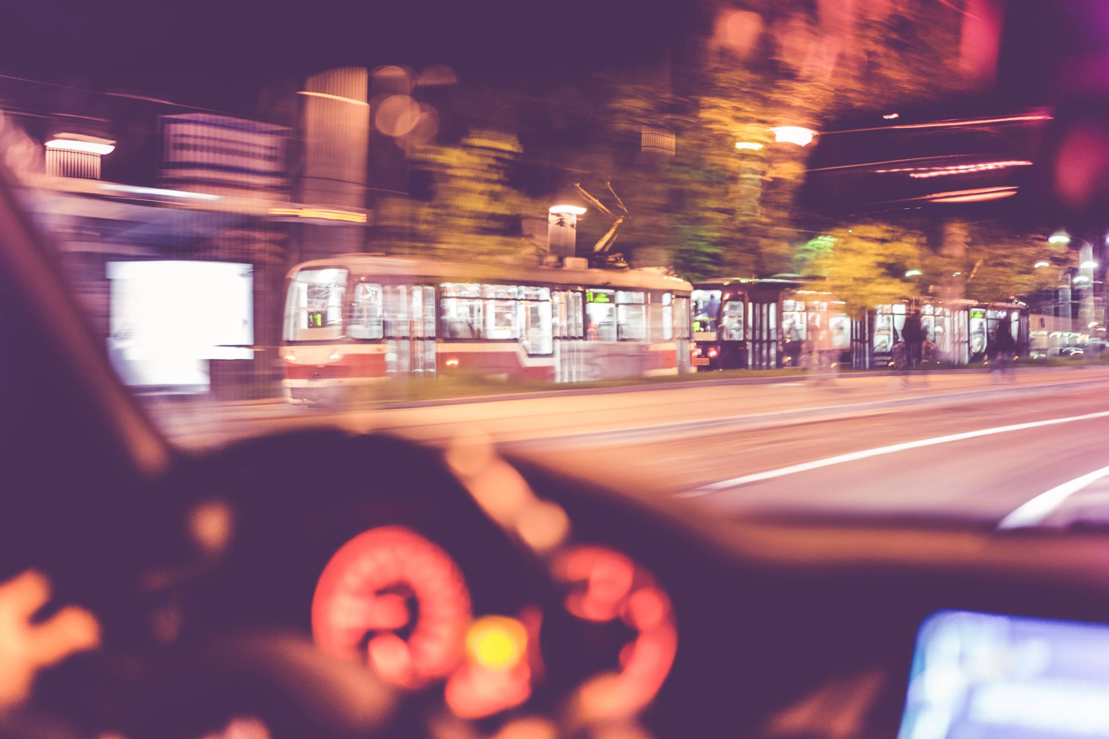 city-tram-vs-car-going-together-at-night.jpg