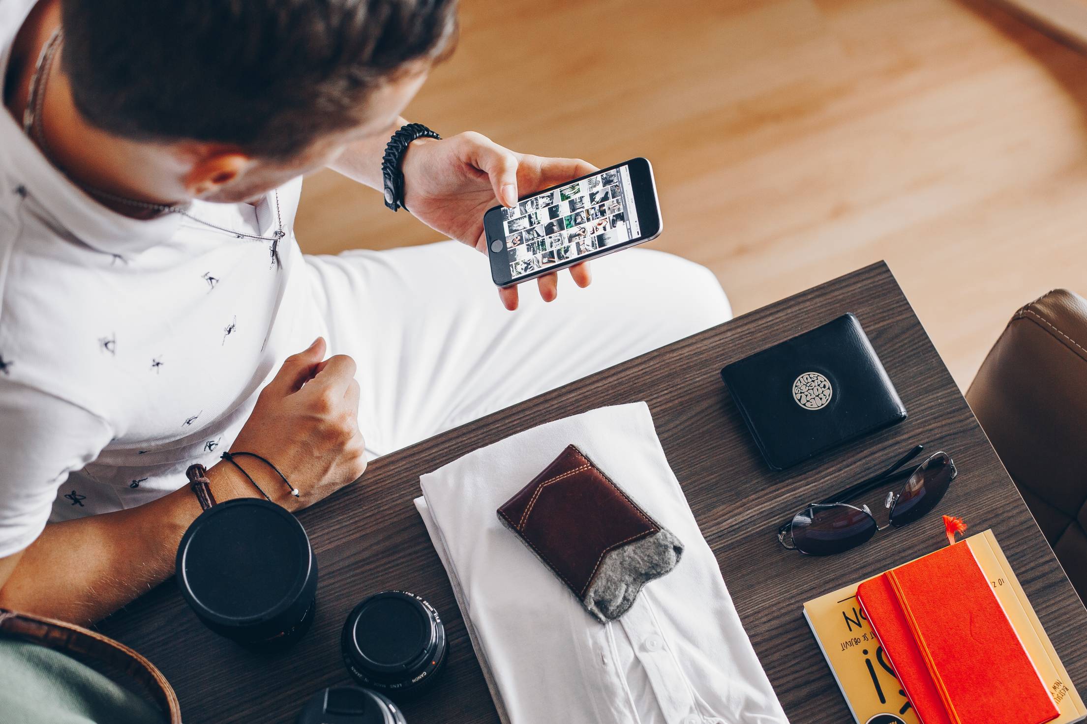 man-browsing-on-his-phone-while-packing.jpg